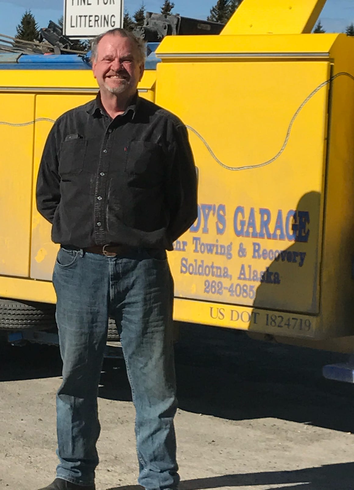 A detailed view of a skateboard with colorful graphics resting on a snowy surface.